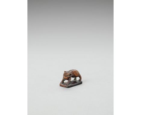   A WOOD NETSUKE OF A KIRIN  Unsigned  Japan, 19th century, Edo period (1615-1868)    The kirin standing on a flat rectangula