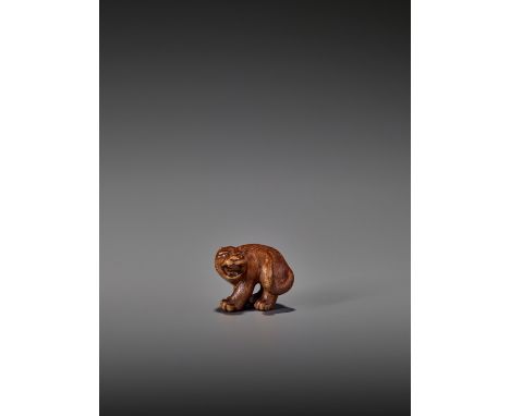   A RARE WOOD NETSUKE OF A SNARLING TIGER  Unsigned  Japan, 19th century, Edo period (1615-1868)    A compact wood netsuke of