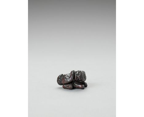   A LARGE DARK WOOD NETSUKE OF A RECLINING GROOMING SHISHI  Unsigned  Japan, 18th century, Edo period (1615-1868)    A powerf