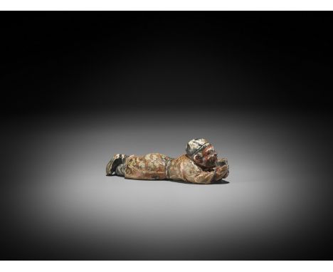   A SAISHIKI NETSUKE OF A RECLINING COURT OFFICIAL  Unsigned  Japan, Osaka, 19th century, Edo period (1615-1868)    Published
