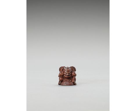   A WOOD NETSUKE OF SHOKI SEARCHING FOR AN ONI  Unsigned  Japan, Meiji period (1868-1912)    The Demon Queller with a fierce 