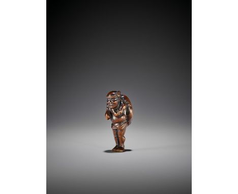   A RARE WOOD NETSUKE OF A FISHERMAN WITH FUGU  Unsigned  Japan, 19th century, Edo period (1615-1868)    An amusing wood nets