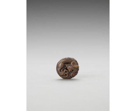   FUSHO: A BOXWOOD MANJU NETSUKE OF A COILED DRAGON  Signed Fusho  Japan, 19th century    Finely carved as a sinuously coiled