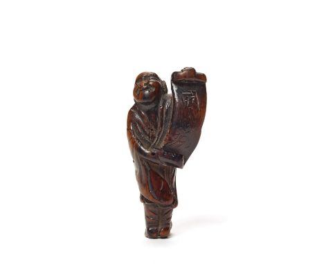   A WOOD NETSUKE OF A MAN WITH SCROLL, C. 1800 TO EARLY 19TH CENTURY  Japan, c. 1800 to early 19th century, Edo period (1615-