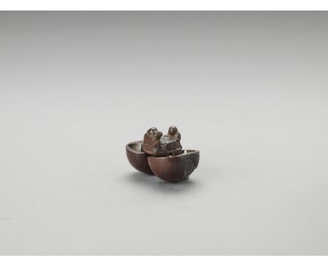   A WOOD KARAKURI NETSUKE WITH HOTEI AND KARAKO PLAYING SUGOROKU  Unsigned  Japan, 19th century to Meiji period (1868-1912)  