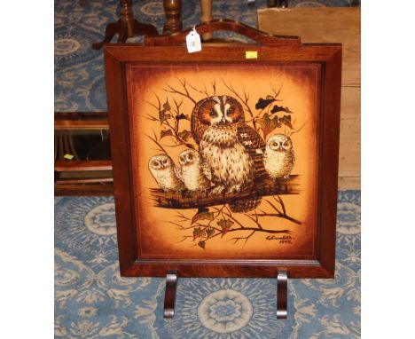A mahogany firescreen with owl panel
