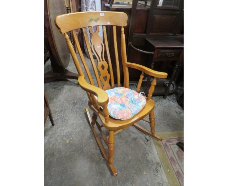 A MODERN LIGHT COLOURED ROCKING CHAIR