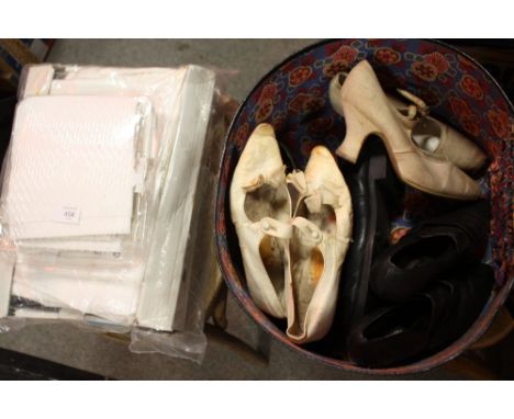 A VINTAGE LEATHER HAT BOX CONTAINING VINTAGE SHOES TOGETHER WITH A COLLECTION OF TABLECLOTHS
