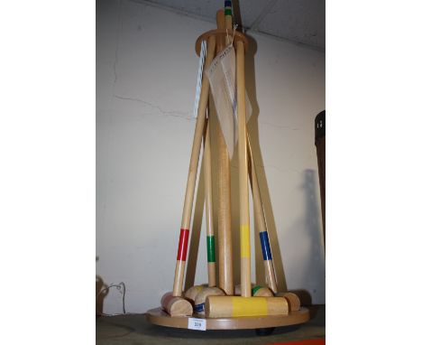 A MODERN WOODEN CROQUET SET