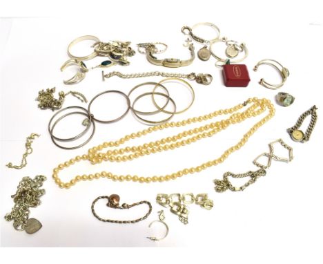 A QUANTITY OF SILVER AND WHITE METAL COSTUME JEWELLERY the silver jewellery to include an Egyptian bangle, two other bangles,