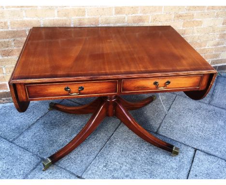 A REPRODUCTION SOFA TABLE  with two frieze drawers, on quatrefoil supports, 72cm deep 108cm wide (176cm including leaves)