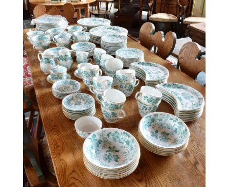 AN EXTENSIVE WEDGWOOD DINNER AND TEA SERVICE  with green transfer printed foliate decoration within gilt borders