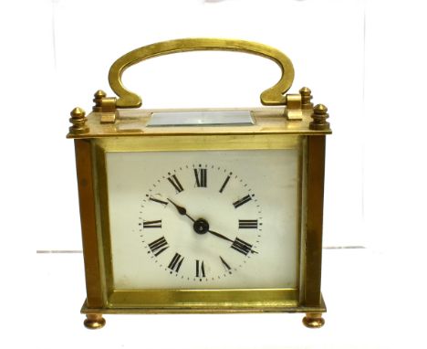 A BRASS CASED CARRIAGE CLOCK  with French movement, the enamel with Roman numerals, 9.5cm wide 9cm high