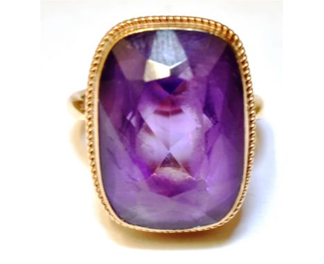 AN AMETHYST SINGLE STONE 9CT GOLD DRESS RING  The cushion shaped amethyst 18mm x 13mm, ring size M, gross weight approx. 6.7g