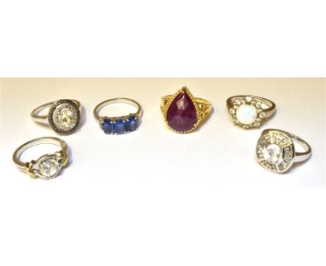 SIX SILVER STONE SET RINGS  to include an opal cluster and a silver gilt single stone set with a large pear cut glass filled 