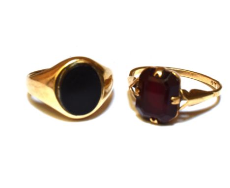 TWO 9CT GOLD STONE SET RINGS  Comprising a black onyx set small signet ring, size G; and a garnet set dress ring, size K; tot