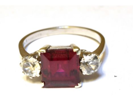 A SYNTHETIC RUBY AND SYNTHETIC WHITE SPINEL THREE STONE RING  Claw settings to a 9ct white gold shank, ring size K, gross wei