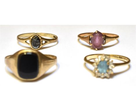 FOUR 9CT GOLD RINGS  Comprising two stone set dress rings; to include an amethyst set and a blue zircon and scroll diamond se