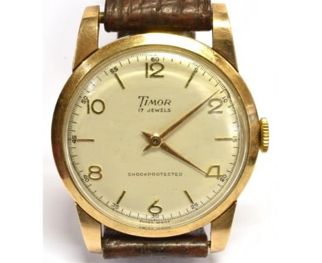 A 1950's TIMOR 9CT GOLD GENT'S WRISTWATCH On a leather strap, round white dial, Arabic numerals, mechanical crown winding sev