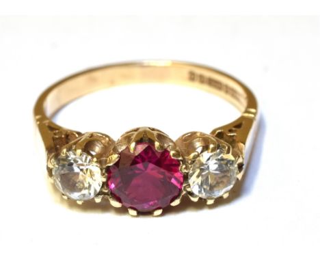 A SYNTHETIC RUBY AND SYNTHETIC WHITE SPINEL ZIRCONIA THREE STONE RING  Claw set to a 9ct yellow gold shank, ring size M, gros