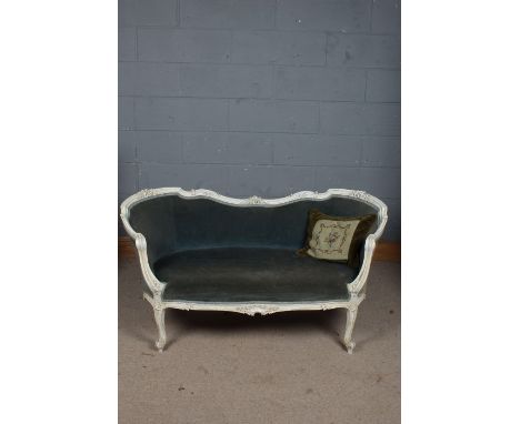 A 20th century French white painted settee/sofa, having a floral carved back rail above a light blue upholstered seat togethe