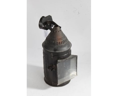 18th century style sheet metal lantern, having hanging loop above a pierced cap and cylindrical body, with glass viewing wind