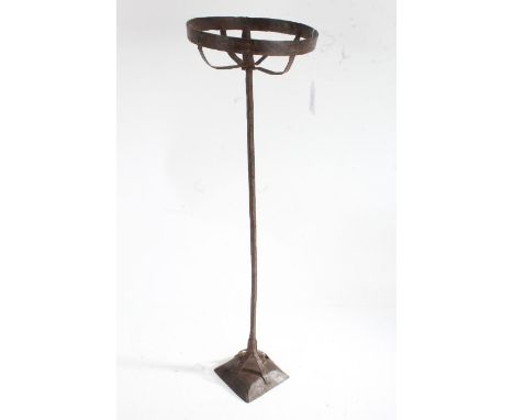 Iron pricket candlestick, the round basket top raised on a square stem and fluted cushion base, 62.5cm high