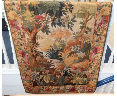 A 19th century wool tapestry of a castle in a woodland