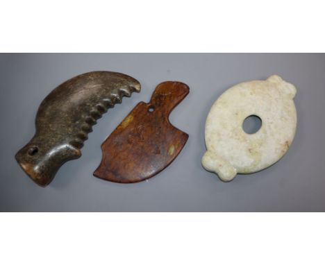 Two Chinese archaistic hardstone axe heads and an oval disc 19cm - 20cm