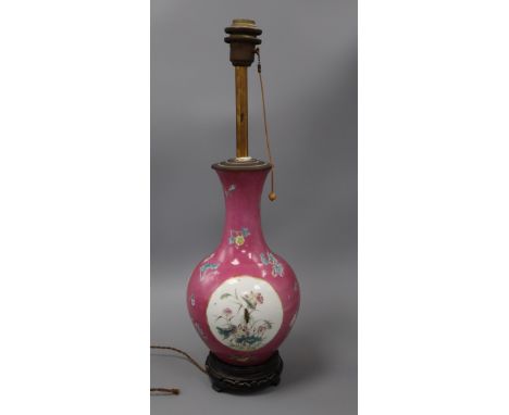 A Chinese ruby sgraffito ground vase, mounted as a lamp, Republic period, with famille rose reserves, 36cm high including woo