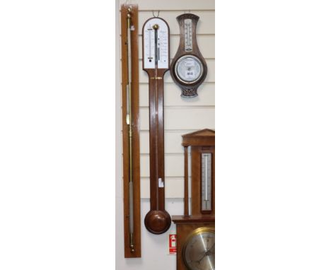 A mahogany cased wheel barometer, thermometer, together with a smaller aneroid barometer/thermometer, a modern brass stick ba