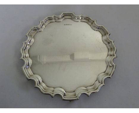 A silver salver with Chippendale border on three scroll legs, Sheffield 1997 by Richard Commyns