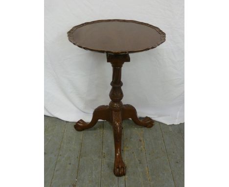 Mahogany pie crust revolving wine table on tripod base with ball and claw feet