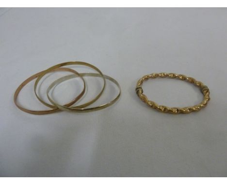 A three hoop 9ct gold bangle and another 9ct gold bangle, approx 33.7g