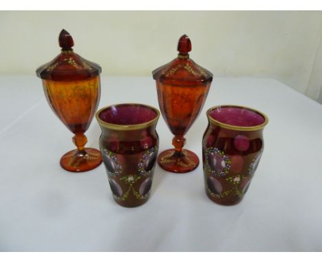 A pair of ruby covered vases and a pair of overlaid hand decorated Bohemian vases
