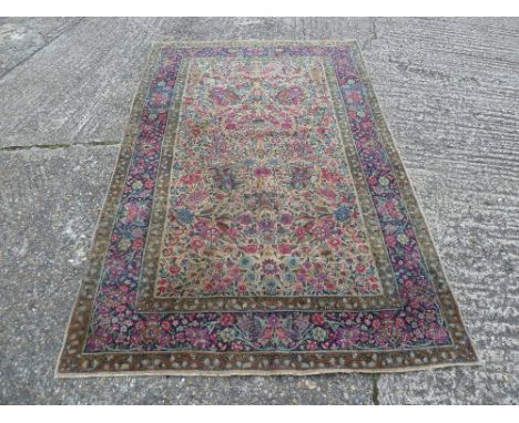 Persian wool Kandahar carpet predominately blue and red floral designs, 217 x 139cm