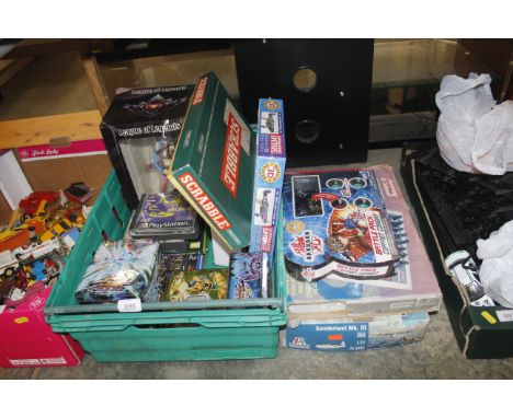 A box containing various video games; a chess computer; model kits etc.