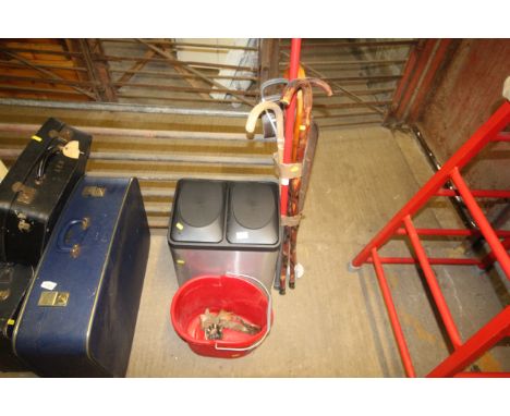 A twin pedestal bin, mop bucket, a bundle of walking sticks with one shooting stick 