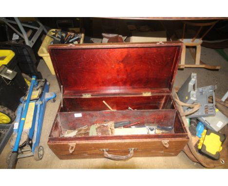 A wooden tool chest containing vintage wood planing tools; saws etc.