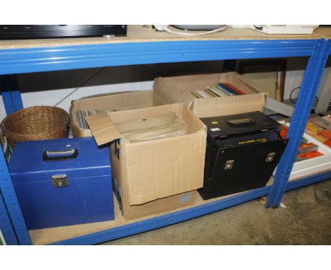 Three boxes containing various records; a Kodak projector; a file box; a wicker basket