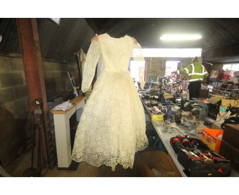 A cardboard box containing a vintage wedding dress