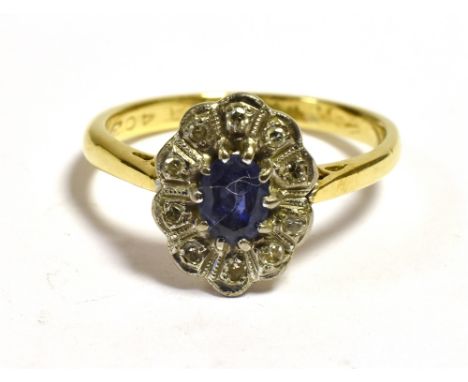 ANTIQUE 18CT SAPPHIRE &amp; DIAMOND RING  Of halo design, 11.2 x 8.7mm oval platinum topped cluster, set with an violet blue 