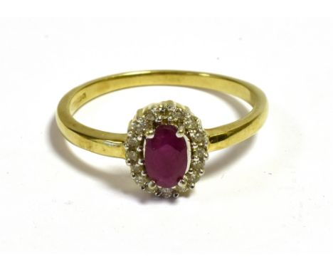 A RUBY &amp; DIAMOND DRESS RING  Mounted in 9ct gold with an oval ruby surrounded by a halo of round brilliant cut diamonds, 