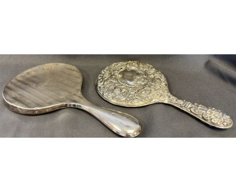 ANTIQUE SILVER MOUNTED HAND MIRRORS  One with repousse floral and bird motif decoration, hallmarked Birmingham 1910 and one w