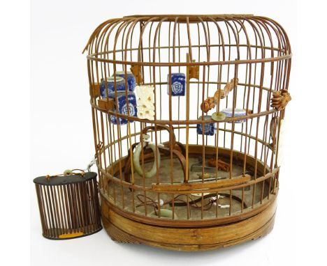 Early 20th Century Chinese Carved Wood Hanging Birdcage with Blue and White Porcelain Feeders, Jade Swings and Carved Ivory O