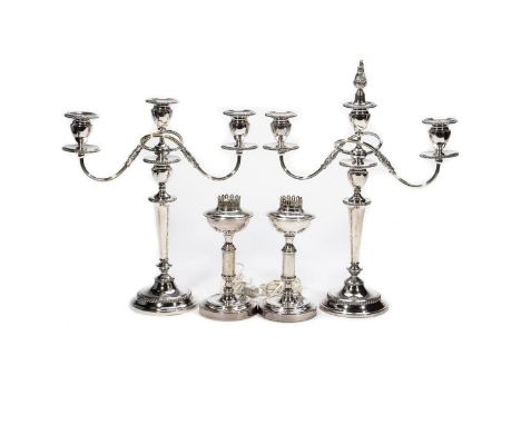 In the Neoclassical style with scrolling candlearms on tapering supports.together with a pair of Neoclassical lamp bases. 19i