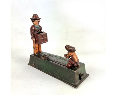 This Antique Organ Grinder and Monkey Cast Iron Mechanical Bank features a classic scene of a street performer and his traine