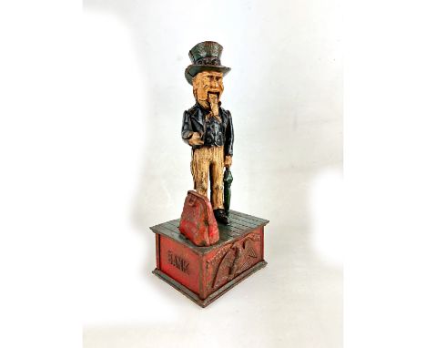This is an antique cast iron mechanical money bank featuring the iconic figure of Uncle Sam. The bank shows Uncle Sam dressed