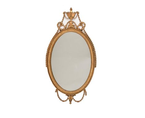A GILTWOOD AND COMPOSITION OVAL WALL MIRROR IN GEORGE III STYLE20TH CENTURY133cm high, 70cm wideCondition Report: Marks, knoc