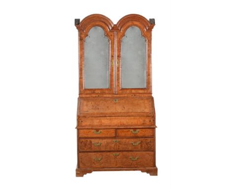 A WALNUT AND BURR WALNUT BUREAU CABINETEARLY 18TH CENTURY AND LATERThe mirrored doors enclosing a removable section with draw